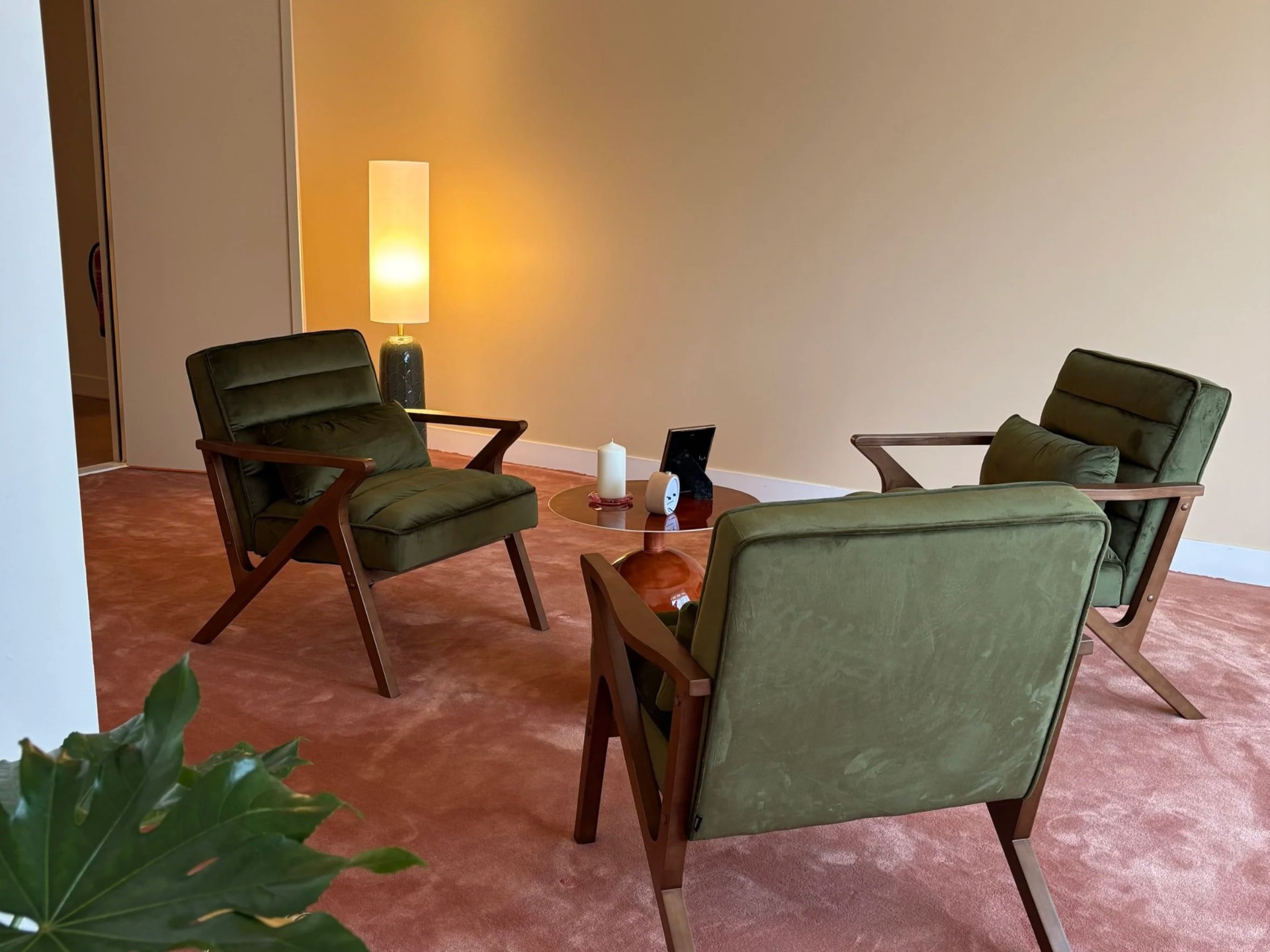Green velvet chairs in a warmly lit group room